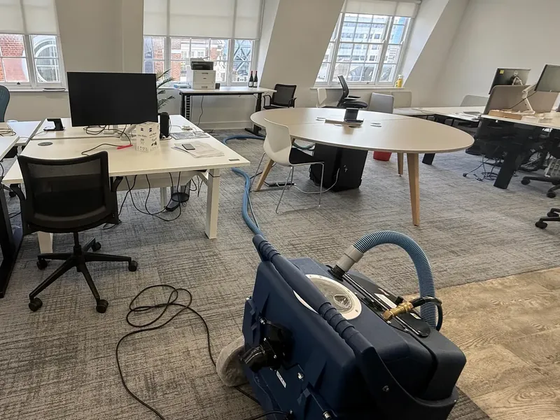 Commercial carpet cleaning underway in an open-plan office