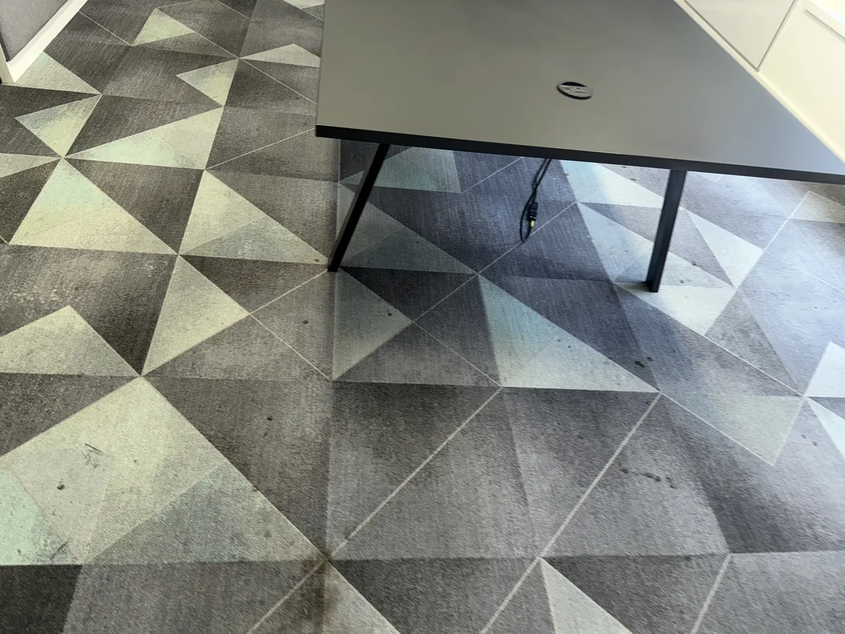 Close view of carpet tiles with traffic soiling worked into the pile